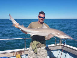 Angler holding a Tope