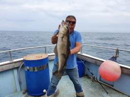 Angler	holding up Large Pollack