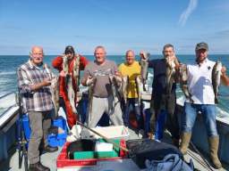 Several Happy Anglers holding up Codling